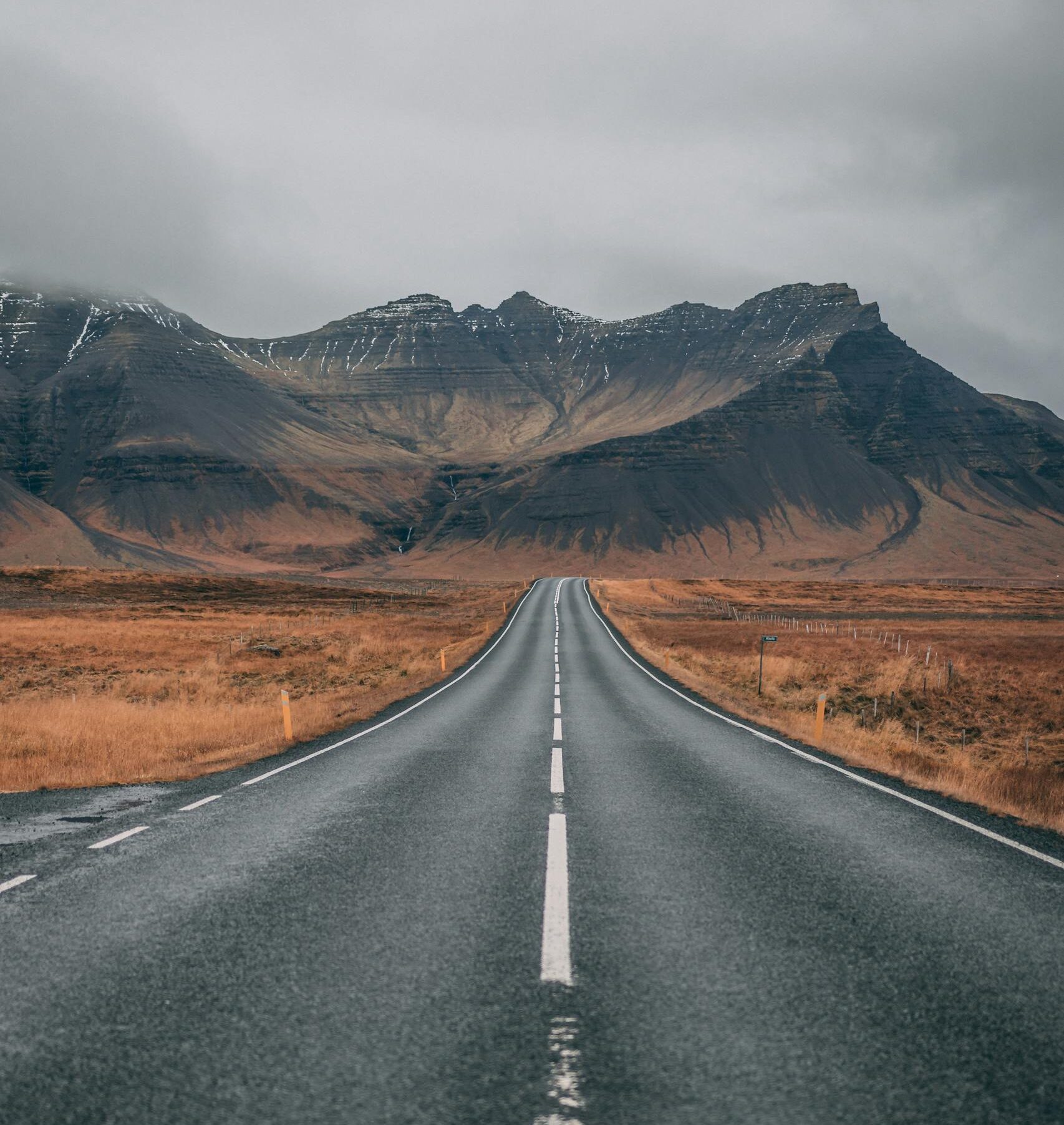 Empty Highway Overlooking Mountain Under Dark Skies